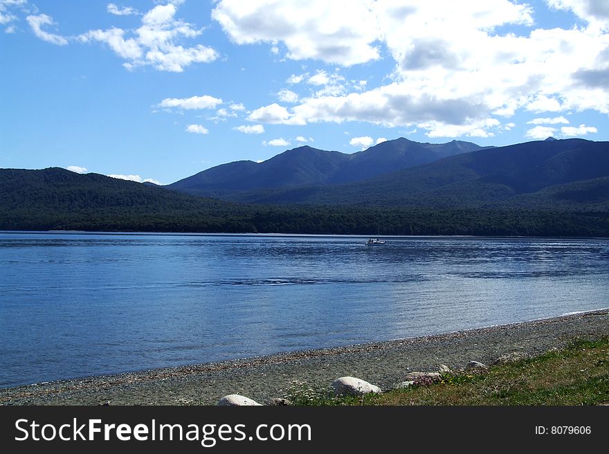 Scenic photo of a Lake with mountains in the background somewhere in New Zealand