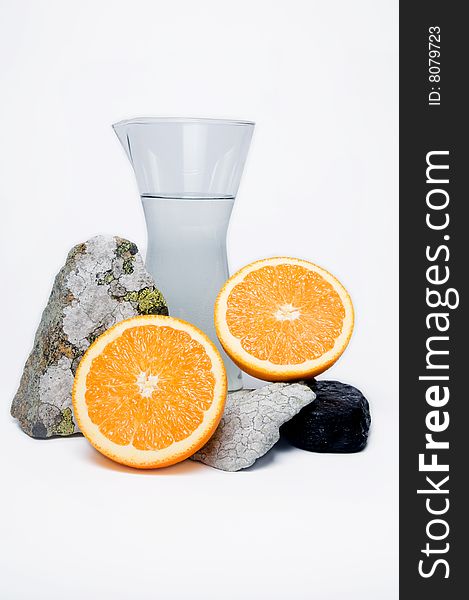 Still life of water, stones and oranges