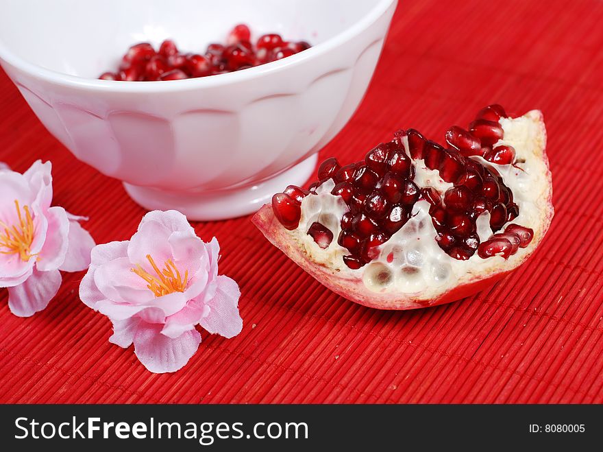 Red seeds of sweet pomegranate in white bowl. Red seeds of sweet pomegranate in white bowl