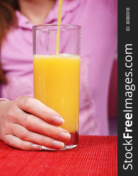 Woman pour a glass of fresh juice. Woman pour a glass of fresh juice