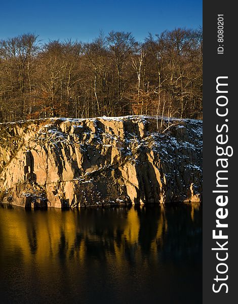 Rocky shore of a small lake in winter setting (Sweden)