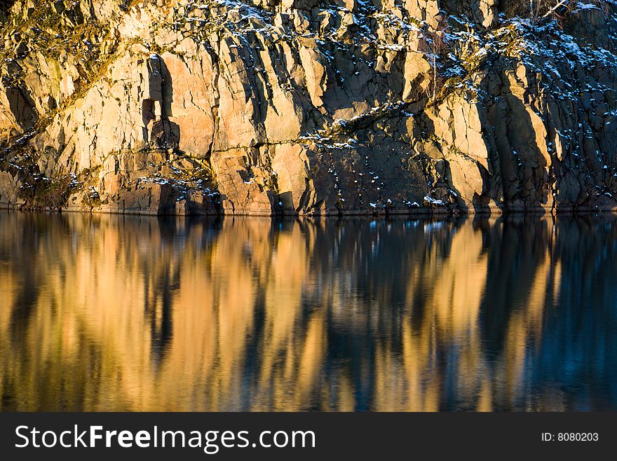 Rock and their reflection in the water in winter setting (Sweden). Rock and their reflection in the water in winter setting (Sweden)