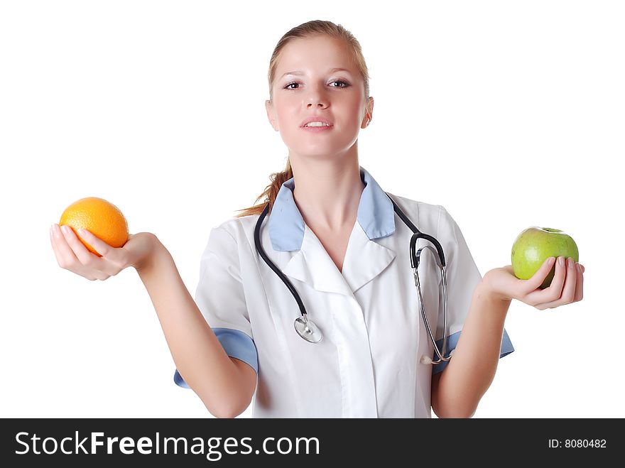 Beautiful nurse with stethoscope and fruits on white background