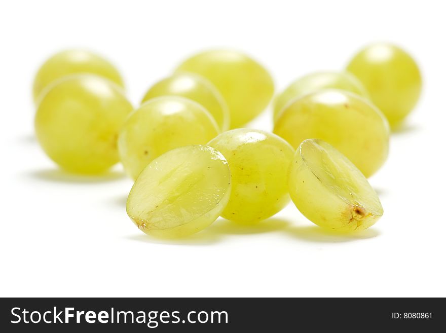 Several grape berries isolated on a white background.