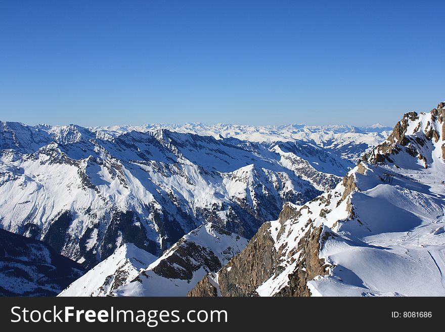 Austria. Mountains. The Alpes.Tops of mountains in a snow and the bright dark blue sky.