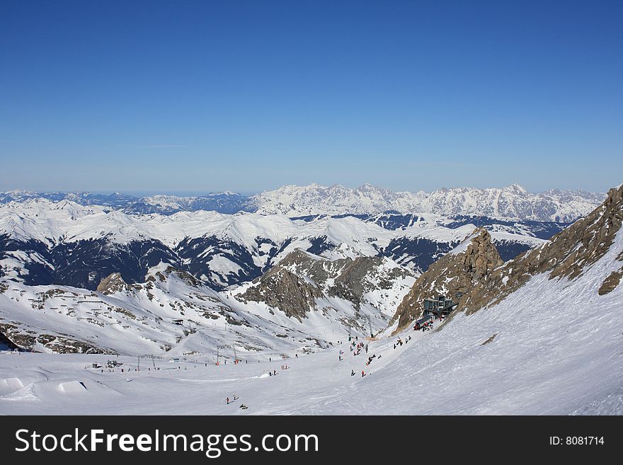 Austria. Mountains. The Alpes.Tops of mountains in a snow and the bright dark blue sky.