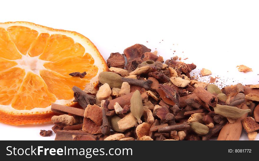 Assorted spices and orange  isolated on white background