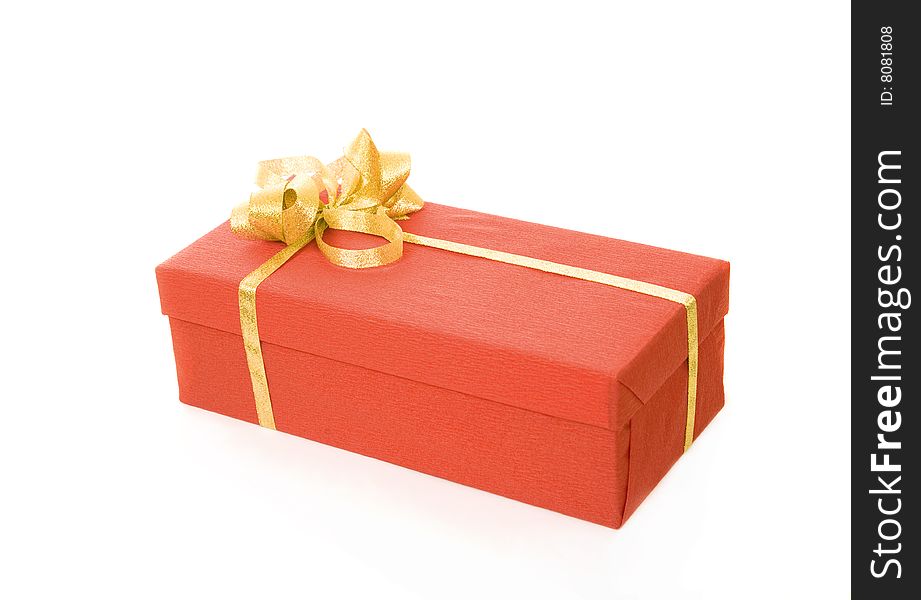 Red gift box over white background with gold ribbon