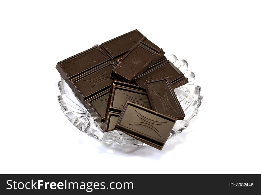 Slabs of black chocolate on glass dish. Slabs of black chocolate on glass dish