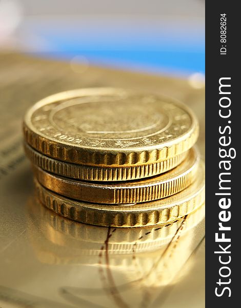 Pile of euro coins on golden background.