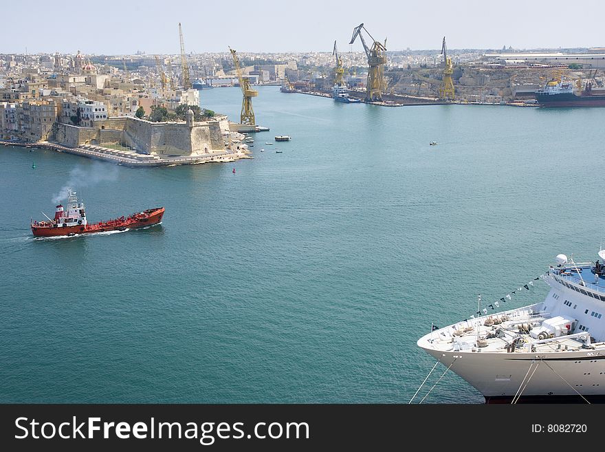 Malta La Valetta view of the harbour with a cruiser and a freighter. Malta La Valetta view of the harbour with a cruiser and a freighter