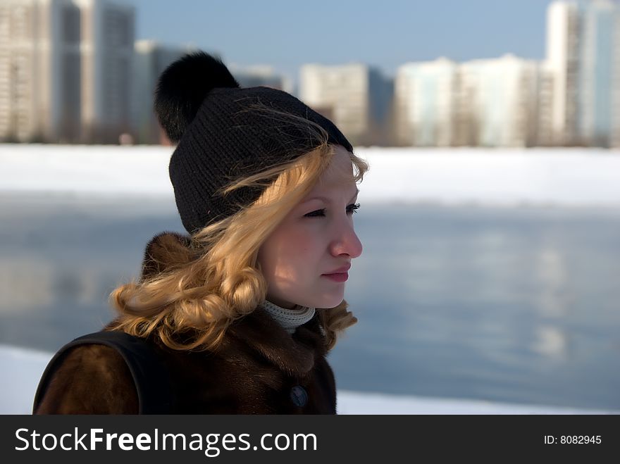 Portrait of the girl of the river walking on coast in the winter. Portrait of the girl of the river walking on coast in the winter