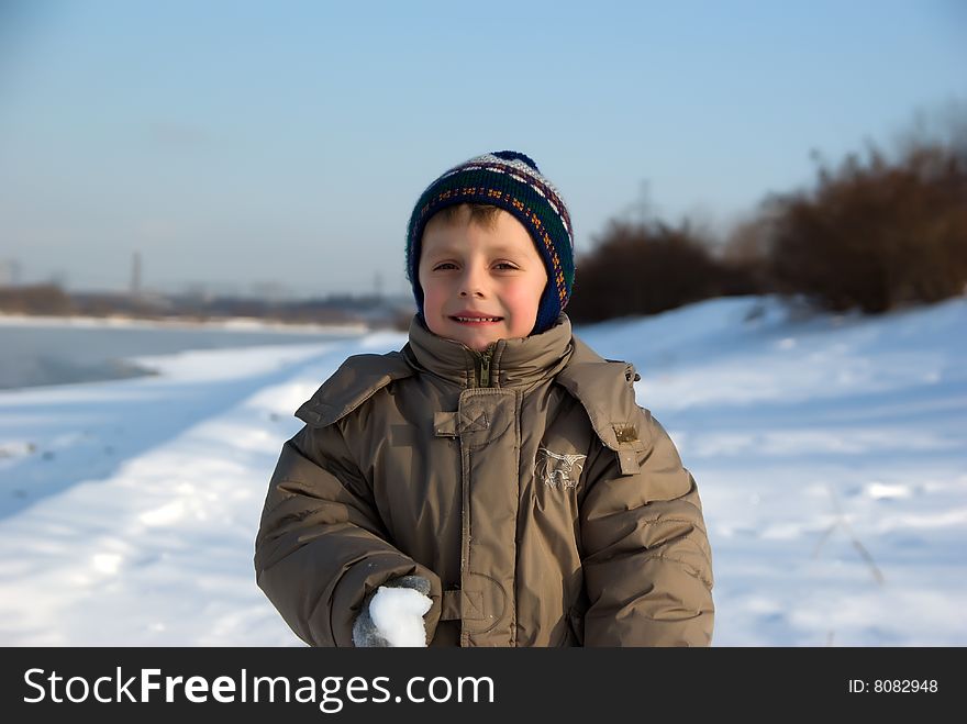 Portrait of the boy walking on coast of the river in the winter. Portrait of the boy walking on coast of the river in the winter