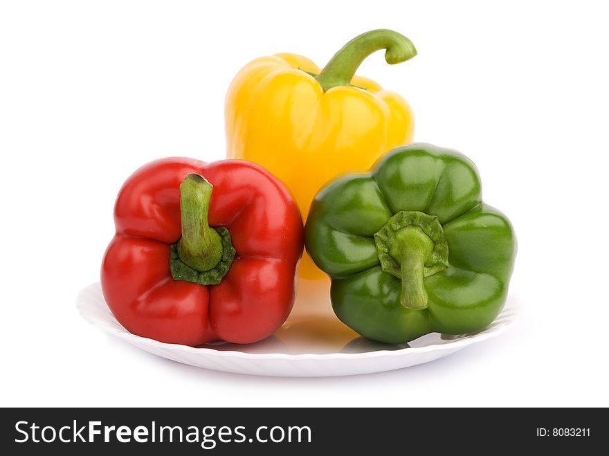 Three colorful peppers on the plate