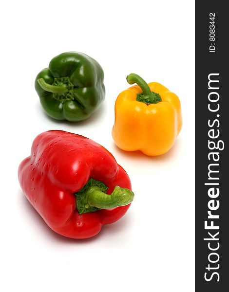 Red yellow and green peppers. Focus is on the red one.