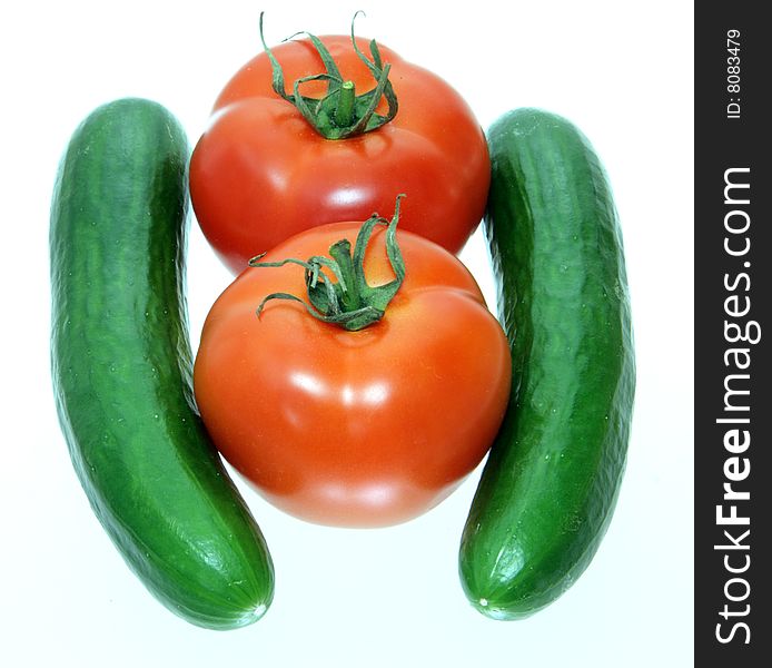 Vegetable tomatoes and cucumbers on white