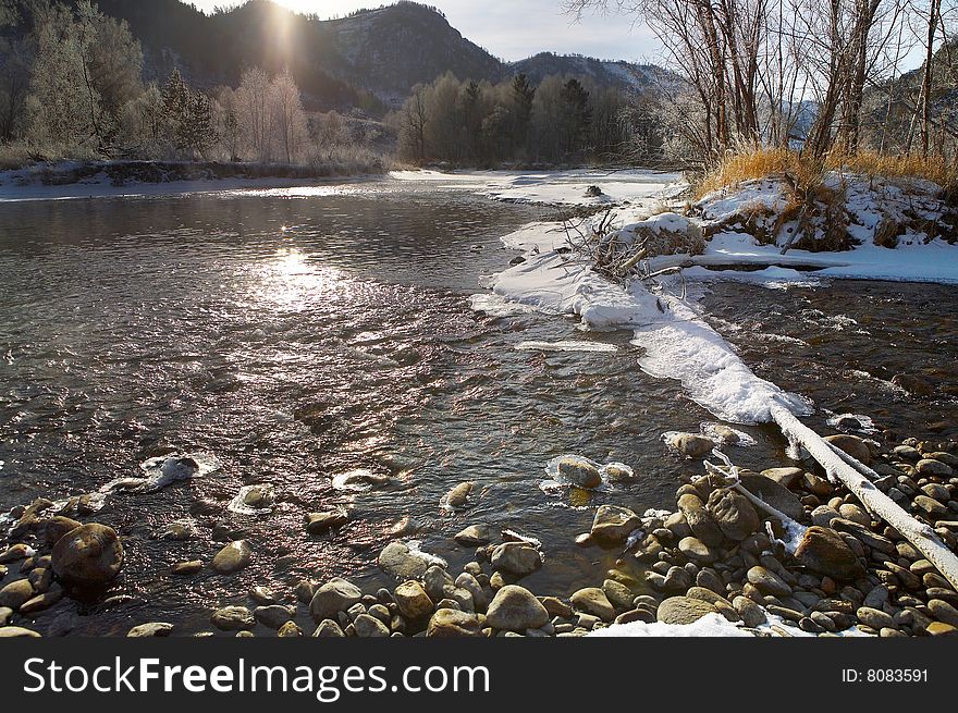 In the winter frosty morning the river in mountains. Russia. Tigiretsky reserve. January. River bank.