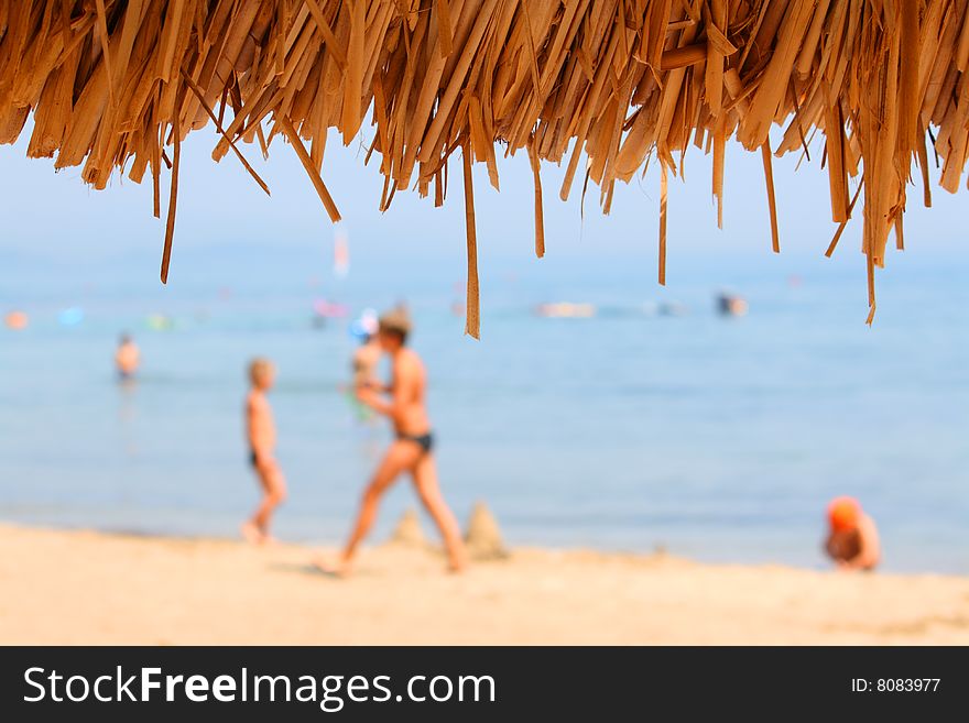 Beach and sea defocused. Looking from sunshade