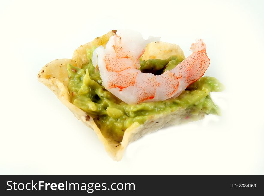 Nacho with guacamole and a shrimp on top. Nacho with guacamole and a shrimp on top.