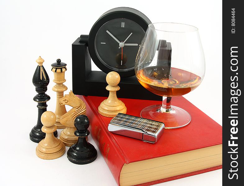 A good book, a glass of cognac , chess and watch. A good book, a glass of cognac , chess and watch