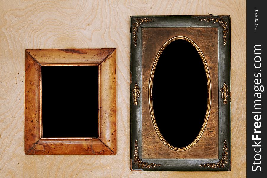 Empty wintage photo-frames on wooden wall