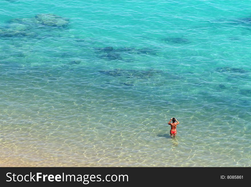 Woman standing in nice water with reefs. Woman standing in nice water with reefs