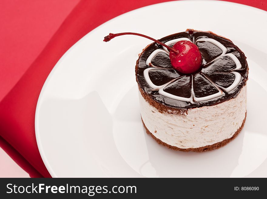 Food serie: sweet fancy cake with chocolate icing and cherry. Food serie: sweet fancy cake with chocolate icing and cherry