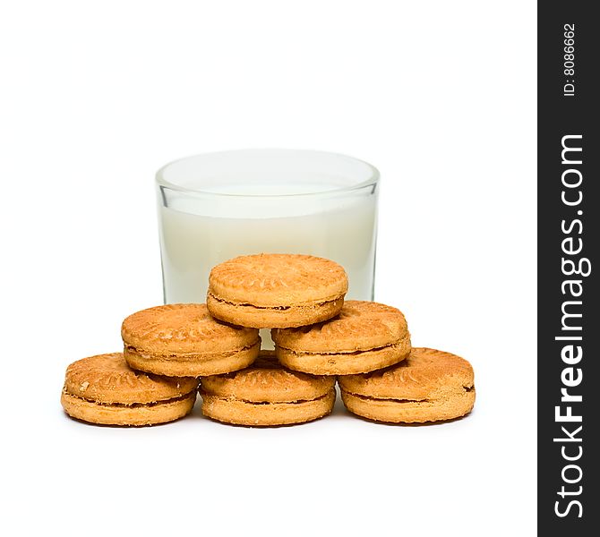 Glass with milk and cakes on plate isolated on white