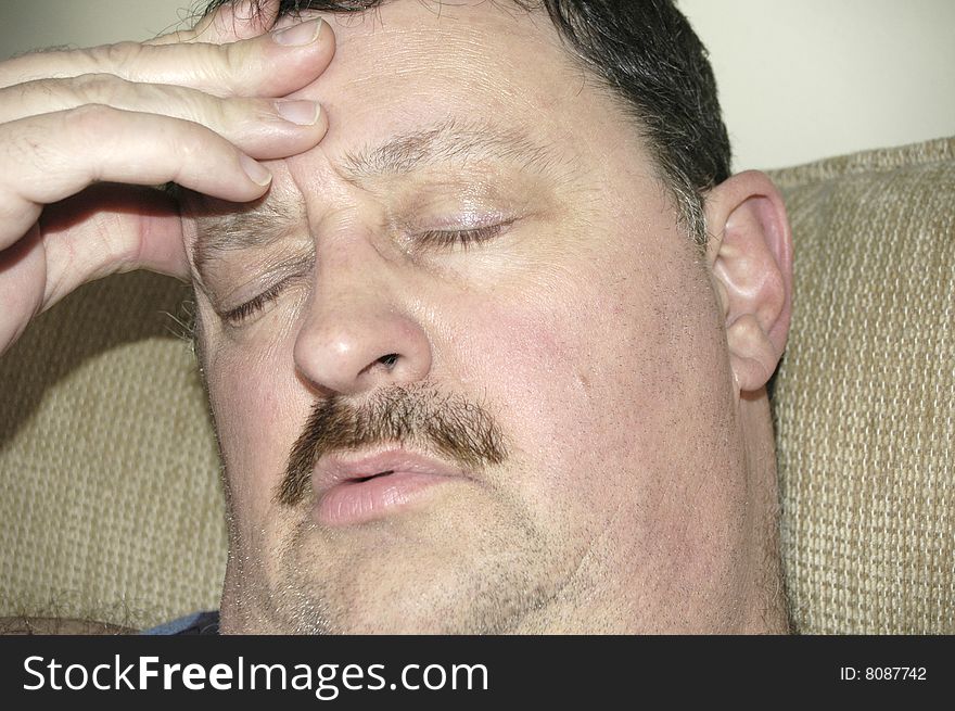 Man suffering from a powerful migraine headache.