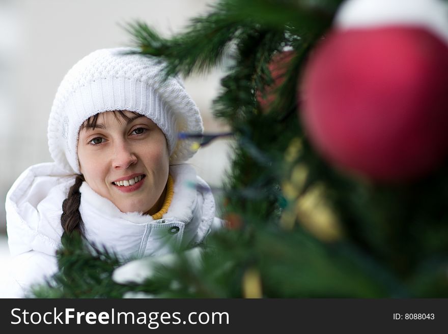 Smiling girl near christmas tree - shallow DOF