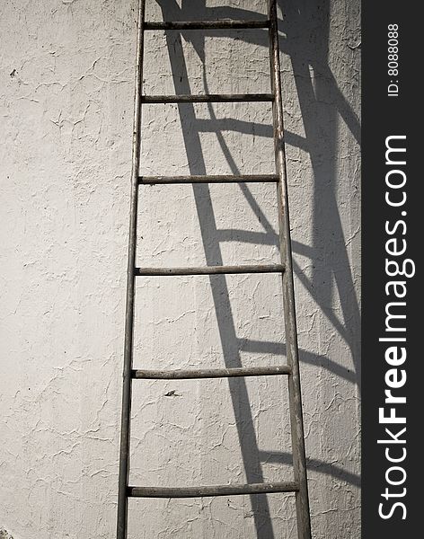 Steps on a blanc wall in sun light