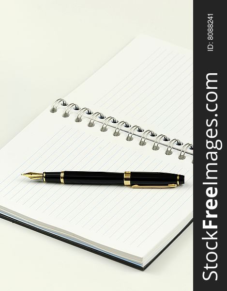 Blank notebook with a fountain pen kept on top. Blank notebook with a fountain pen kept on top