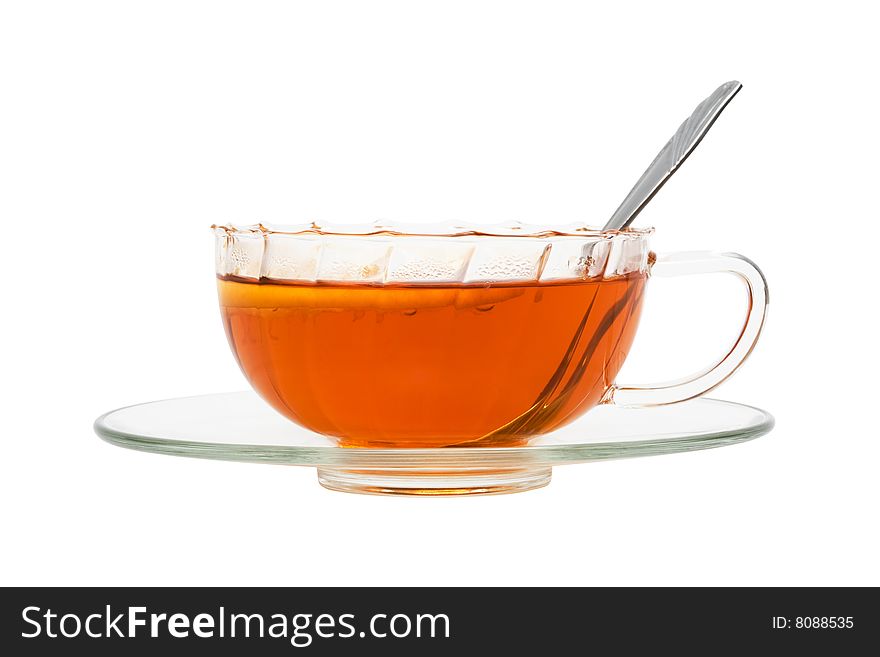 Glass cup with tea and a lemon on a white background