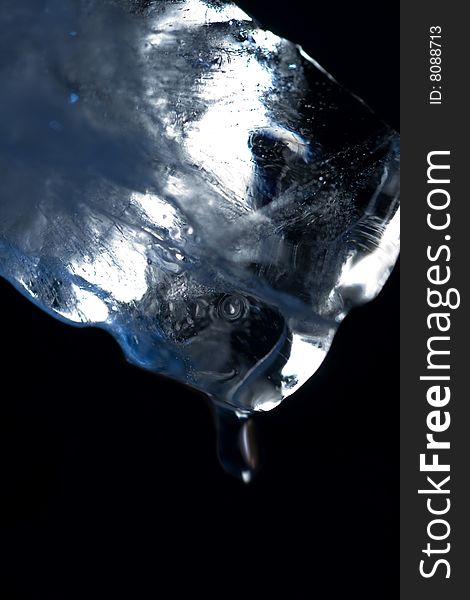 Macro photo of Ice cube with drop