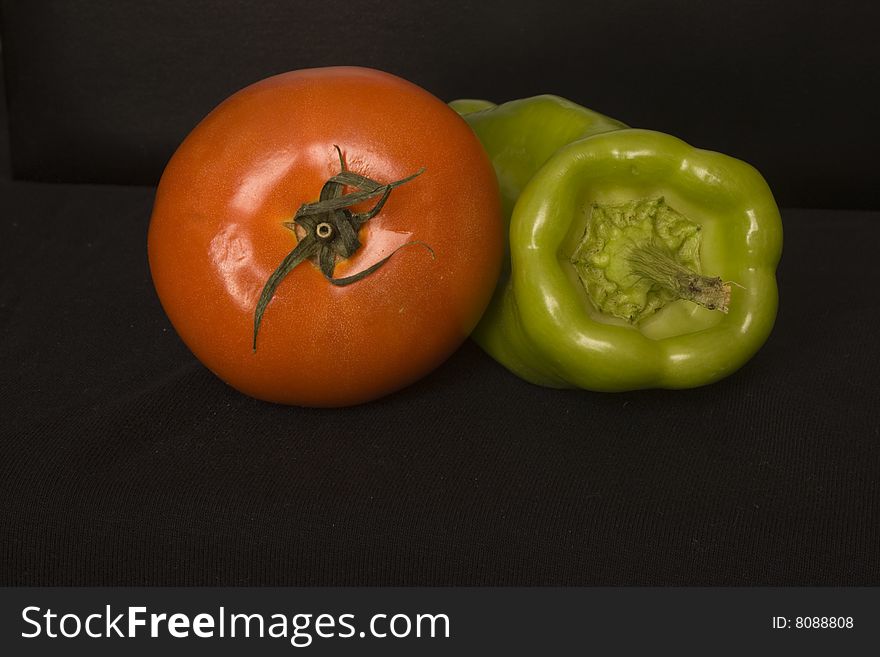 Fresh tomato and green pepper, photographed in the kitchen