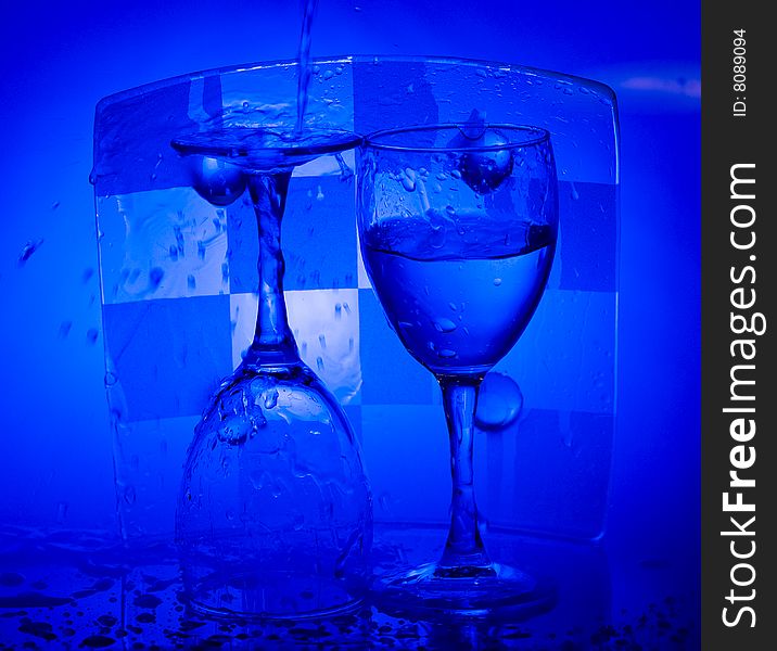 Blue Glass with Splashing water. Coolness Drink. Blue Glass with Splashing water. Coolness Drink