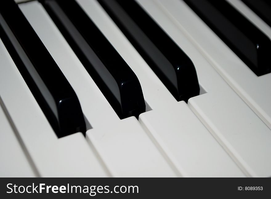 Black and white keys on a keyboard - could be a piano or organ. Black and white keys on a keyboard - could be a piano or organ