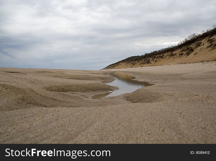 Water inlet, created by the tide, on a sandy beach