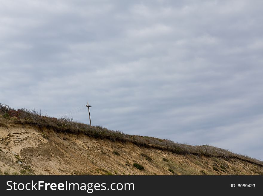 Power line pole in the shape of the cross, on the beach. Power line pole in the shape of the cross, on the beach