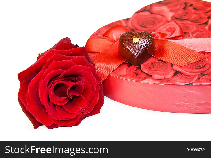 Love and chocolate - red rose and heart chocolates isolated on white. Love and chocolate - red rose and heart chocolates isolated on white.