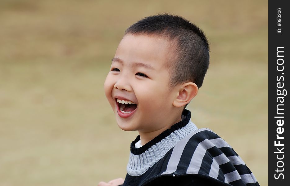 Young boy playing cheerfully in the park. Young boy playing cheerfully in the park