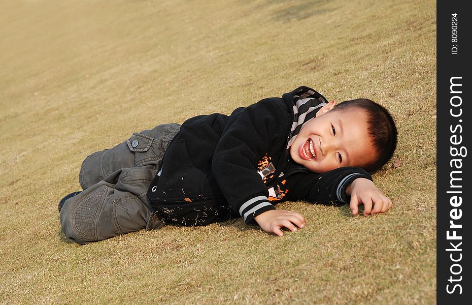 Cute young boy Playing in the park cheerfully. Cute young boy Playing in the park cheerfully