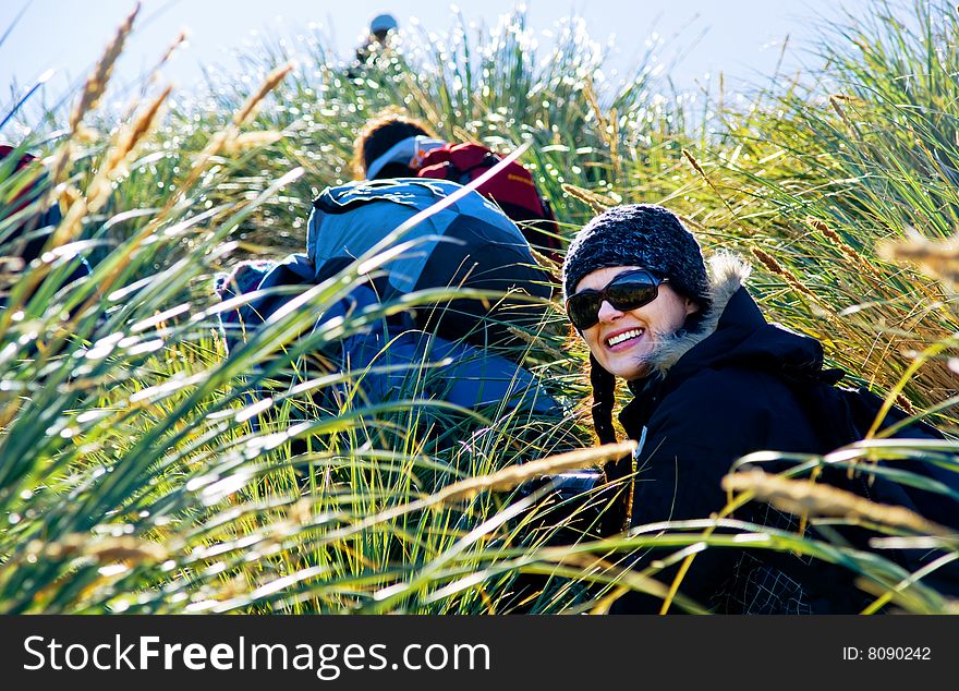 Attractive girl hiking through tussock grass. Attractive girl hiking through tussock grass