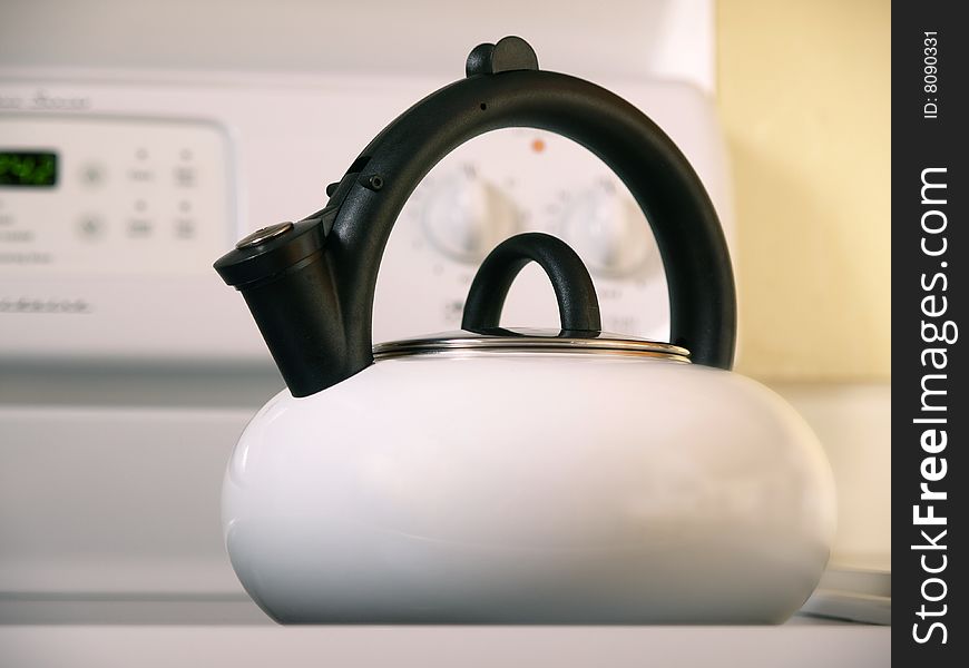 White Tea Kettle angled on white stove