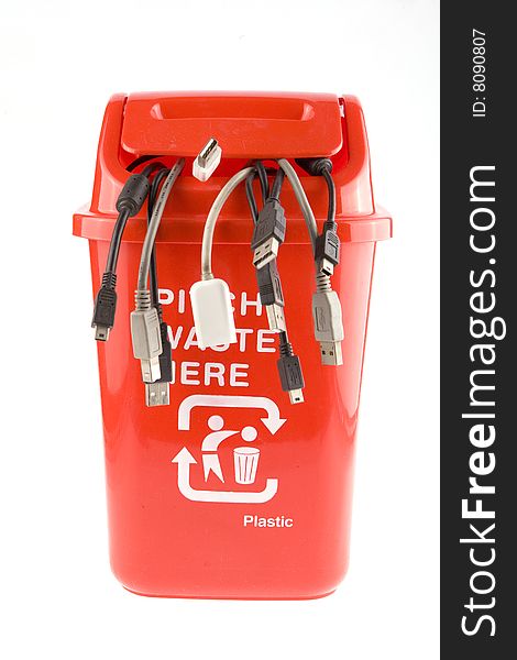 A red recycling bin full of recyclable things-electrical wire,tTerminal.