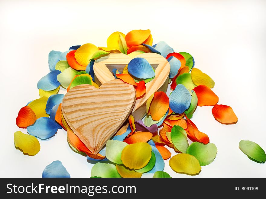 Wood heart box with colored flower petals. Wood heart box with colored flower petals