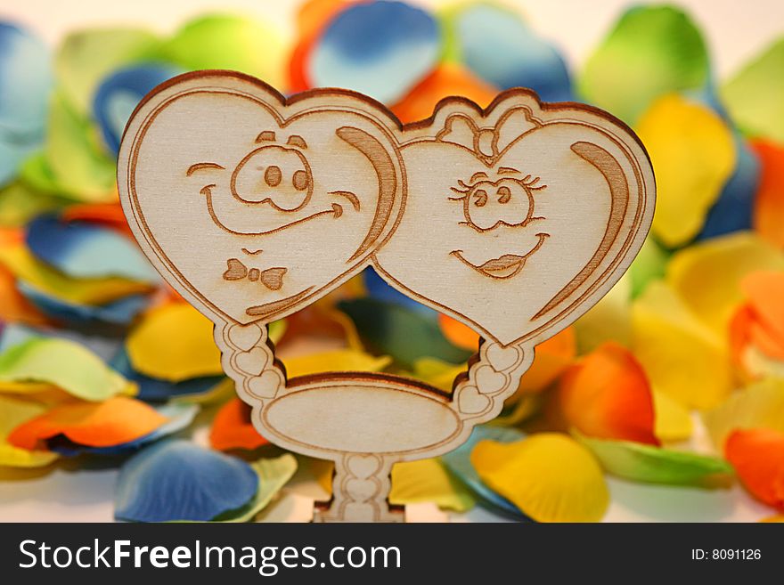 Two wood hearts with colored background - focus on the hearts. Two wood hearts with colored background - focus on the hearts