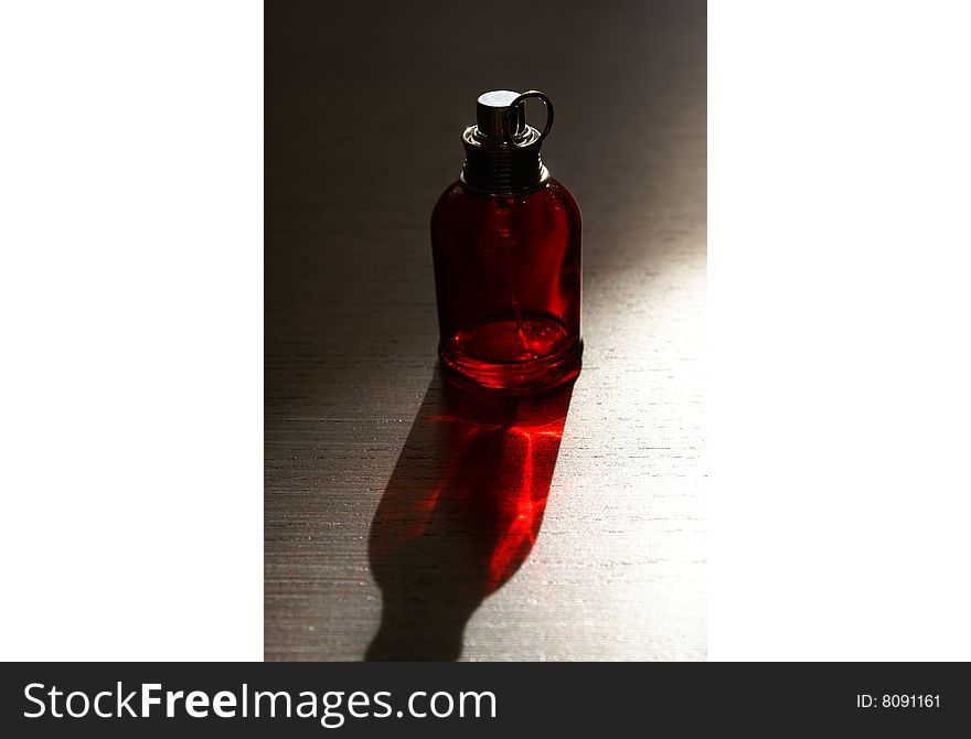 A small red perfume bottle. A small red perfume bottle