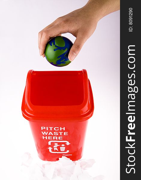 Hand take hold of his globe chuck recycling bin. Hand take hold of his globe chuck recycling bin