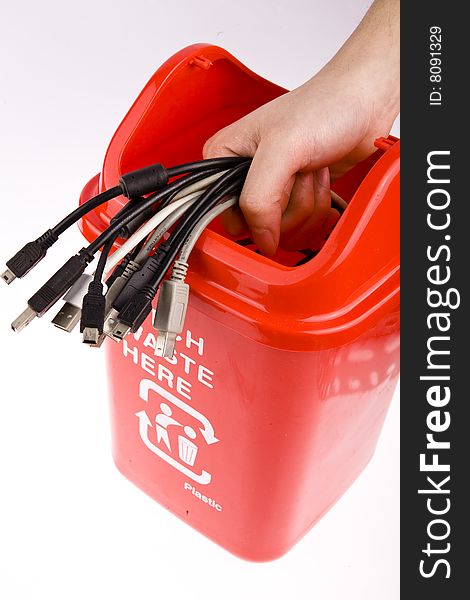 A red recycling bin full of recyclable things-electrical wire,tTerminal.